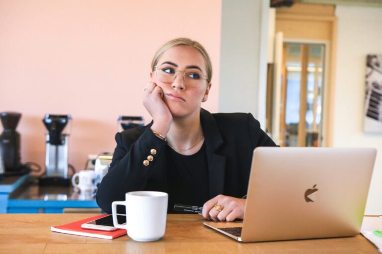 Woman with ADHD, sitting at a computer in her office