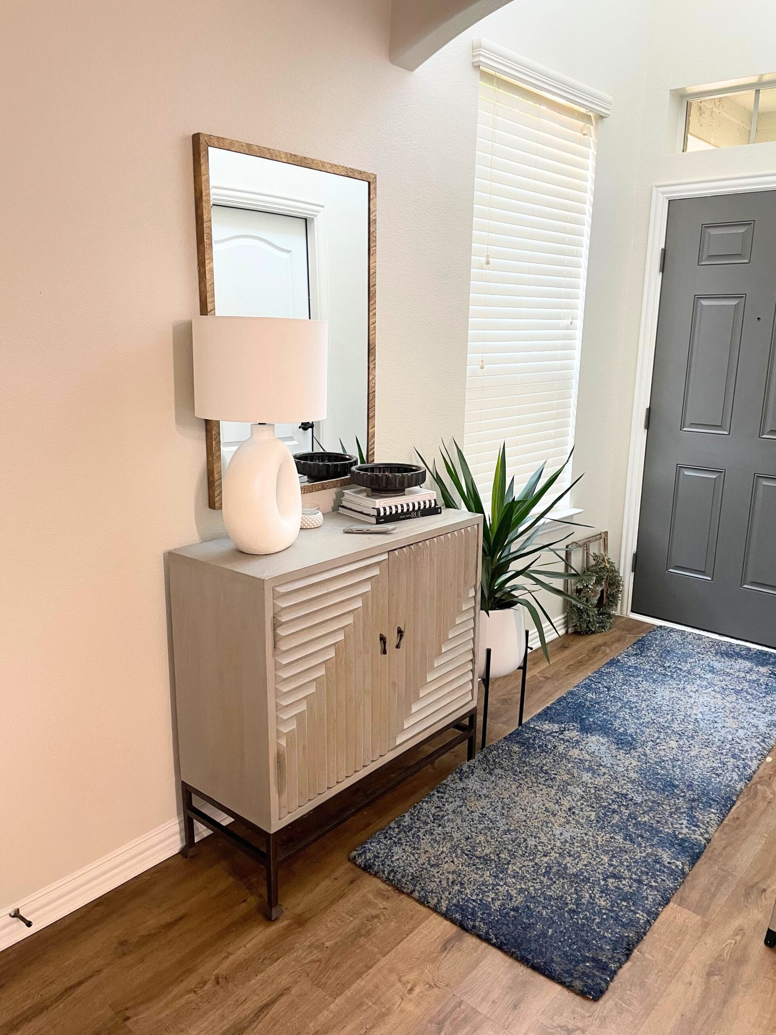 Organized entryway with shoe storage and a basket for pet leash, treats and toys in an Allen TX home